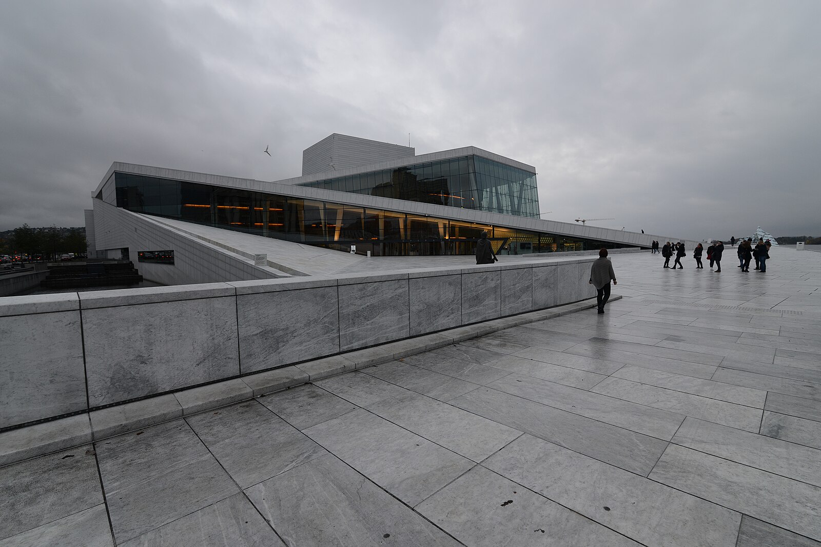 Visitors on the sloping roof of the Oslo Opera House overlooking Bjørvika